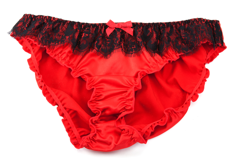 Female red lace panties on white background