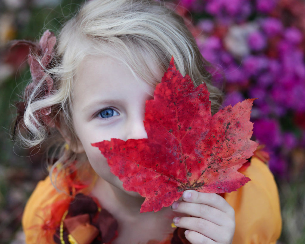 little girl with fall leaf