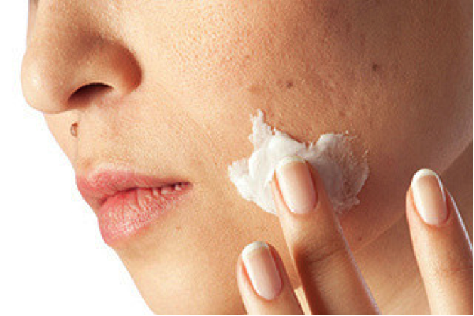 applying cream on face