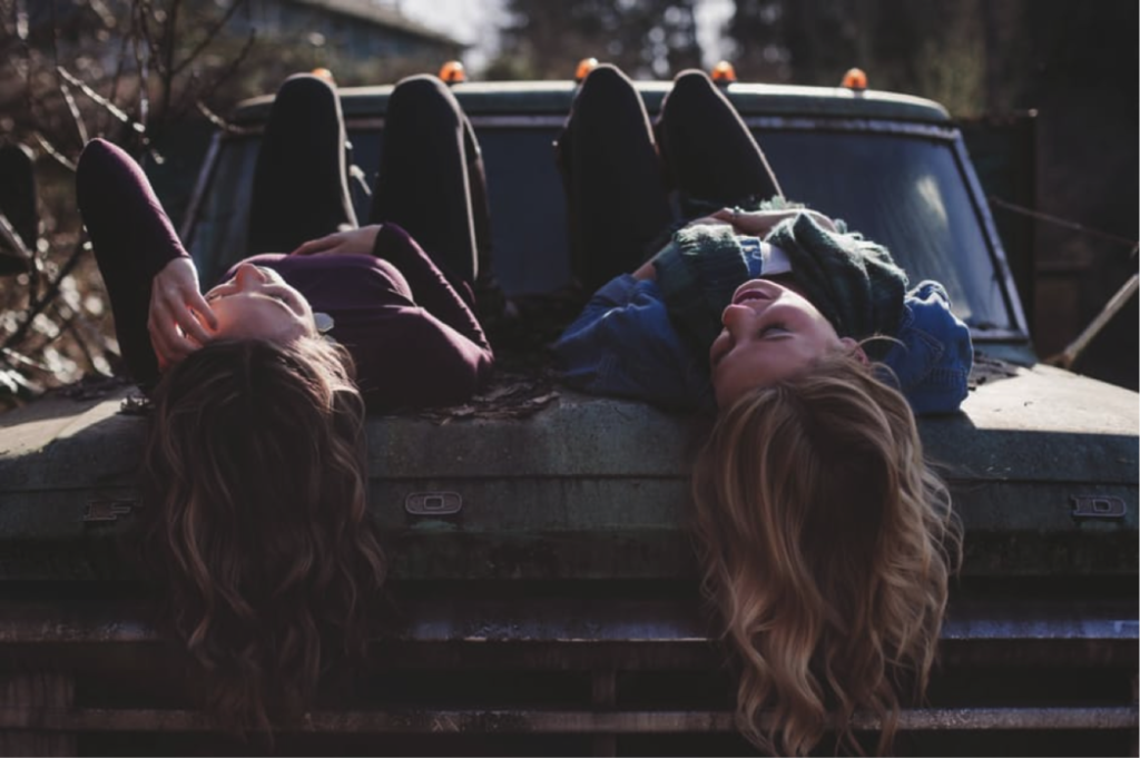 Girls laying on a truck