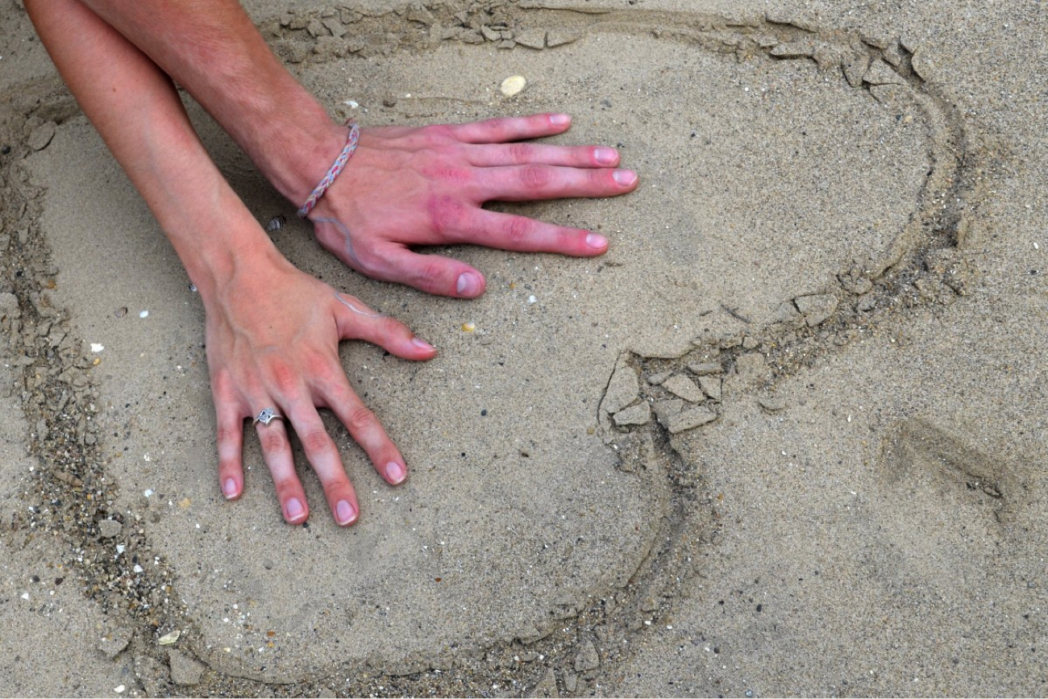 hands in sand
